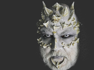 Fototapeta premium man or monster with thorns on face with futuristic makeup