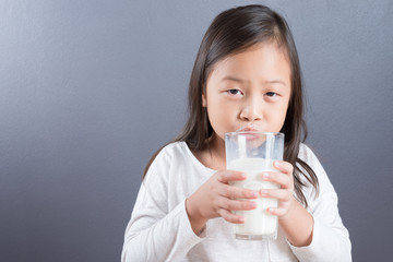 Asian kid cute girl happy to drink milk