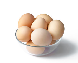 Fresh chicken eggs in a bowl, with shade on white background