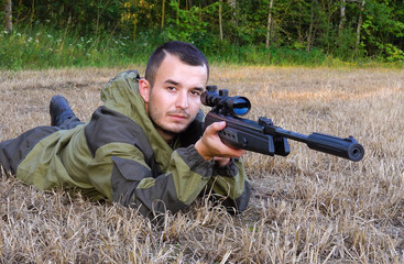 Hunter aiming a gun at wild animals