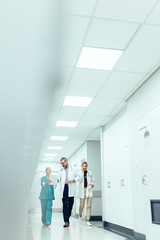 Medical team in hospital corridor discussing work