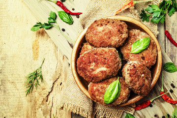 Beef meatballs in a bowl, old wooden background, top view