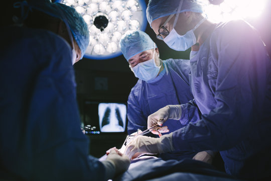 Professional surgeons performing surgery in operating room