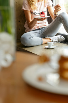 Young girl eating small raspberry cake in Italian restaurant. © cegli