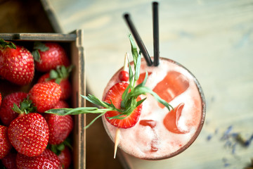 Strawberry lemonade with lime and ice in mason jar on a wooden table jpg