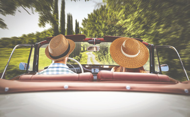 road in tuscany and two lovers in retro car  - obrazy, fototapety, plakaty