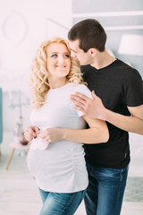Fototapeta premium Pregnant girl with her husband smiling