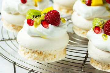 Mini Pavlovas: Meringue, Whipped Cream, Berries, Kiwi, Mango, and Passionfruit