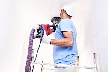 Worker polishes the wall. Plaster finishing float 