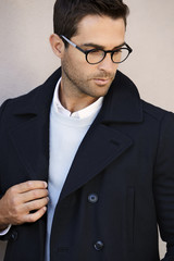 Fashionable fellow in jacket and spectacles, looking away