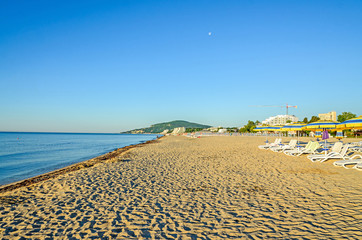 The Black Sea shore from Albena, Bulgaria with golden sands, blue fresh water, sunbeds and...
