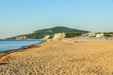 The Black Sea shore from Albena, Bulgaria with golden sands, blue fresh water, sunbeds and...