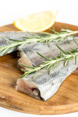 Hake fish with lemon and rosemary branches