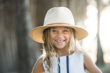 Smiling kid in hat outside