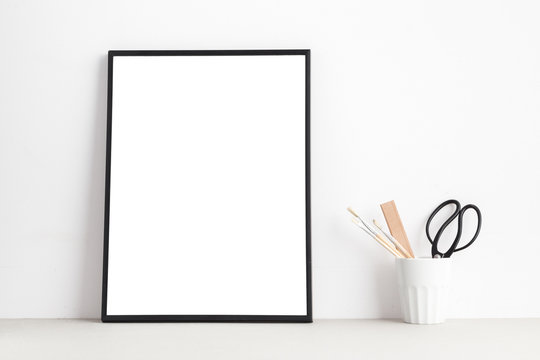 Mock up white poster or picture frame on shelf..