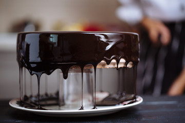 Glazing chocolate mousse cake, close-up - 167459335
