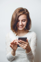 Fototapeta na wymiar Beautiful young girl smiling communicating in social networks smartphone