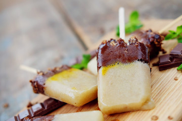 Homemade ice cream. Chocolate banana granola popsicles.