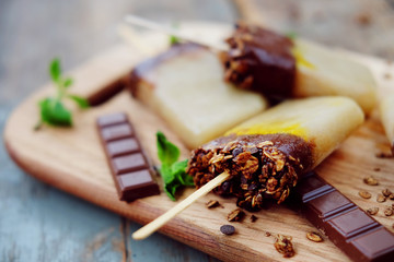 Homemade ice cream. Chocolate banana granola popsicles.