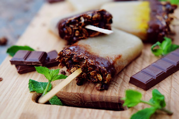 Homemade ice cream. Chocolate banana granola popsicles.
