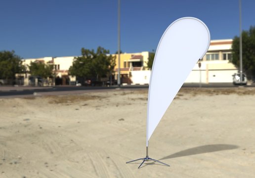 Blank white teardrop bow flag outdoor advertising shield beach flag banner or vertical wind banner mock up template isolated on the beach.