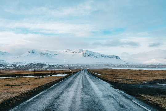 Road in iceland on a cloudy day with mountain in background