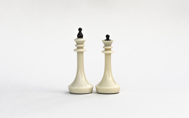 Chess pieces. The white king and Queen on white background