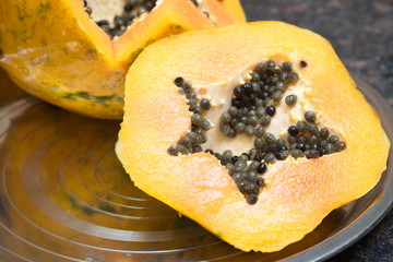 Fresh ripe papaya cut on the table