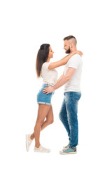'portrait of young attractive couple standing face to face hugging each other, isolated on white
