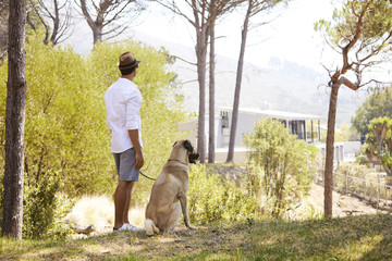Naklejka na ściany i meble Dude and dog admiring view in park
