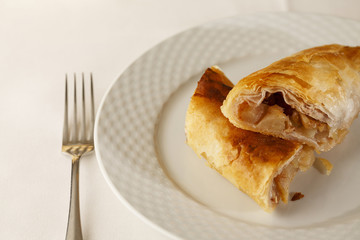 Apple pie slice arranged on a plate, Traditional dessert in elegant setting, Selective focus with soft light