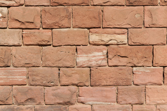 Wall mason out of red sandstone
