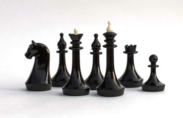 Black chess pieces on white background