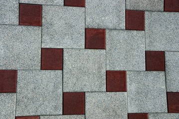 Коричнево серый фон из фрагмента каменной квадратной тротуарной плитки 