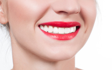 Obraz premium White teeth and red lips. Perfect female smile after whitening teeth.