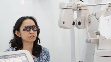 Asian woman test eyesight with professional optometrist for glasses