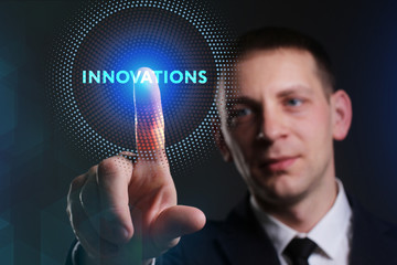 Business, Technology, Internet and network concept. Young businessman working on a virtual screen of the future and sees the inscription: Innovations