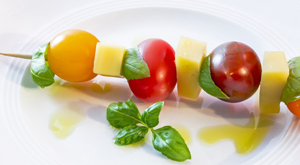 Salad from cherry tomato, cheese, basil, shallot