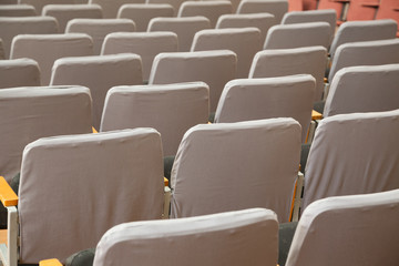 Closeup of old grey seats in cinema