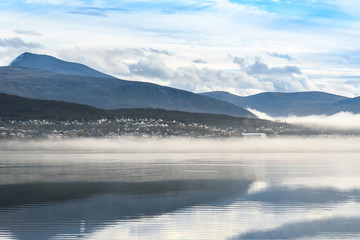 Fototapeta na wymiar Misty fog over the lake, Tromso, Norway