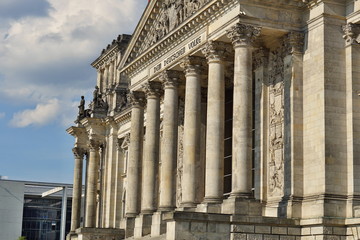 Naklejka premium Architectural detail of the top of the German parliament (Reichstag - Bundestag) in Berlin with decorated columns and symbolic triangle 