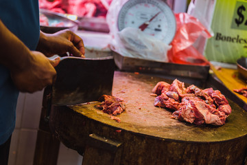 Butcher chopping meat