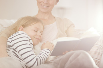 Girl falling asleep while reading book