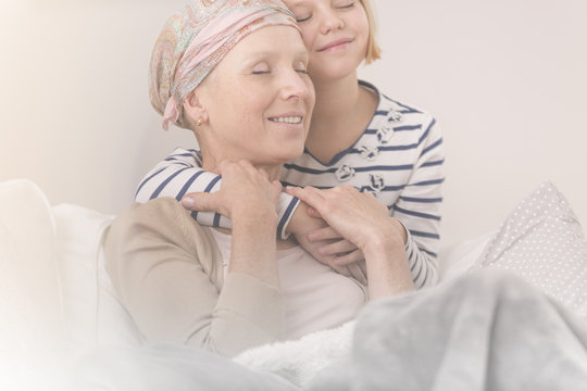 Child embracing mother with leukemia
