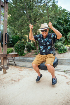 Senior man on swings