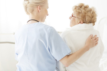 Nurse sitting on a hospital bed