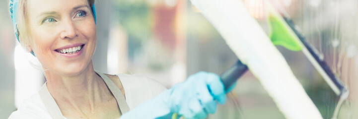 Woman wiping window with squeege