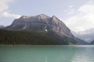 Canoeing on the beautiful emerald colored water of Lake Louise in Banff national park, Alberta, Canada.