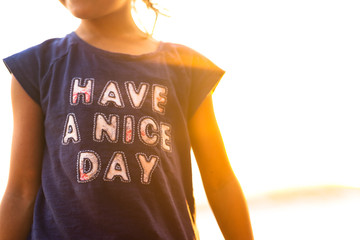 Child with t shirt on saying have a nice day 