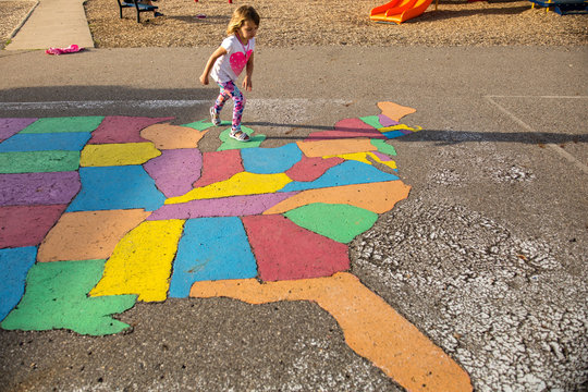 Girl stepping on painted ground map